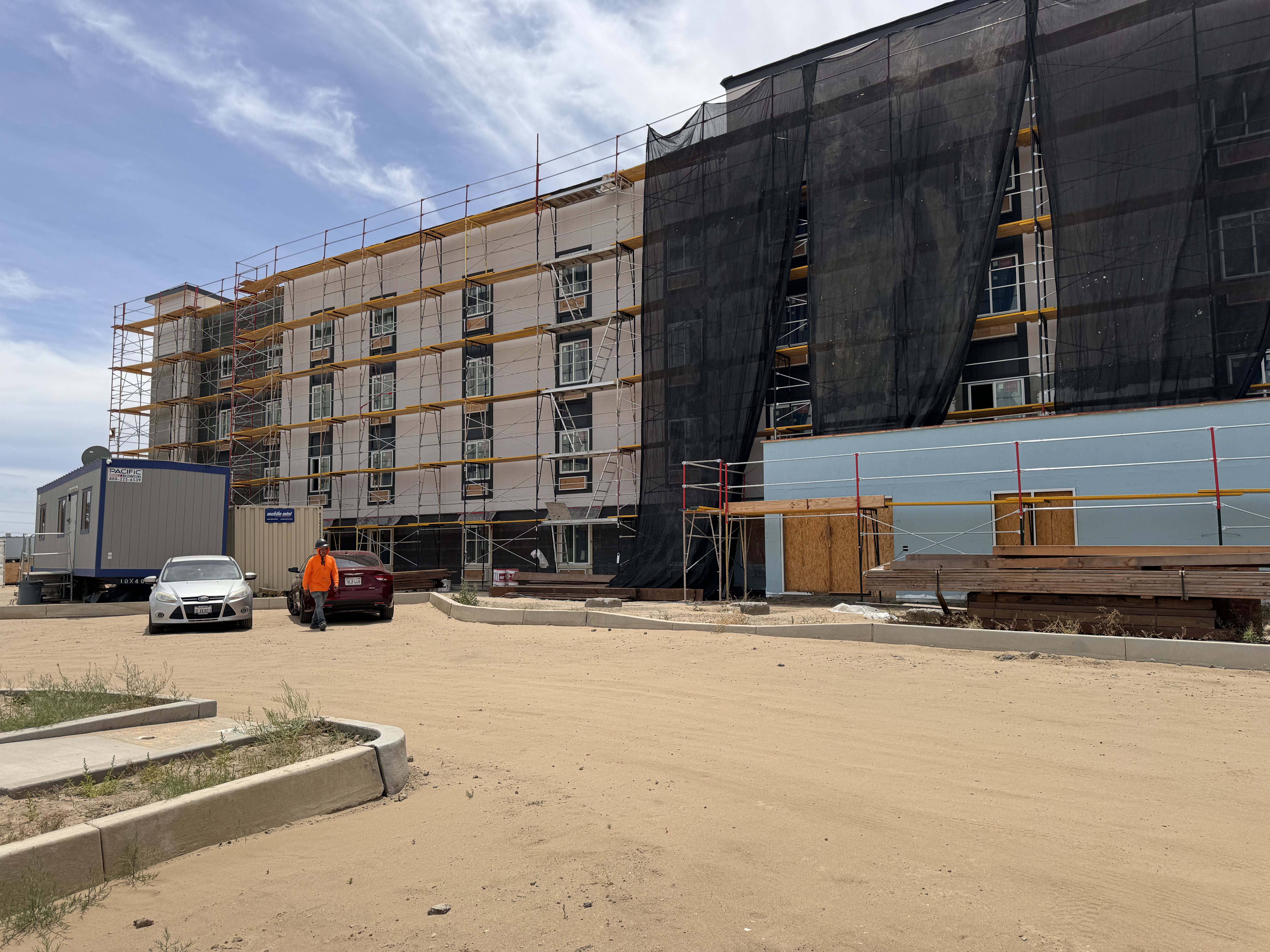 Hotel exterior siding scaffolding mid progress